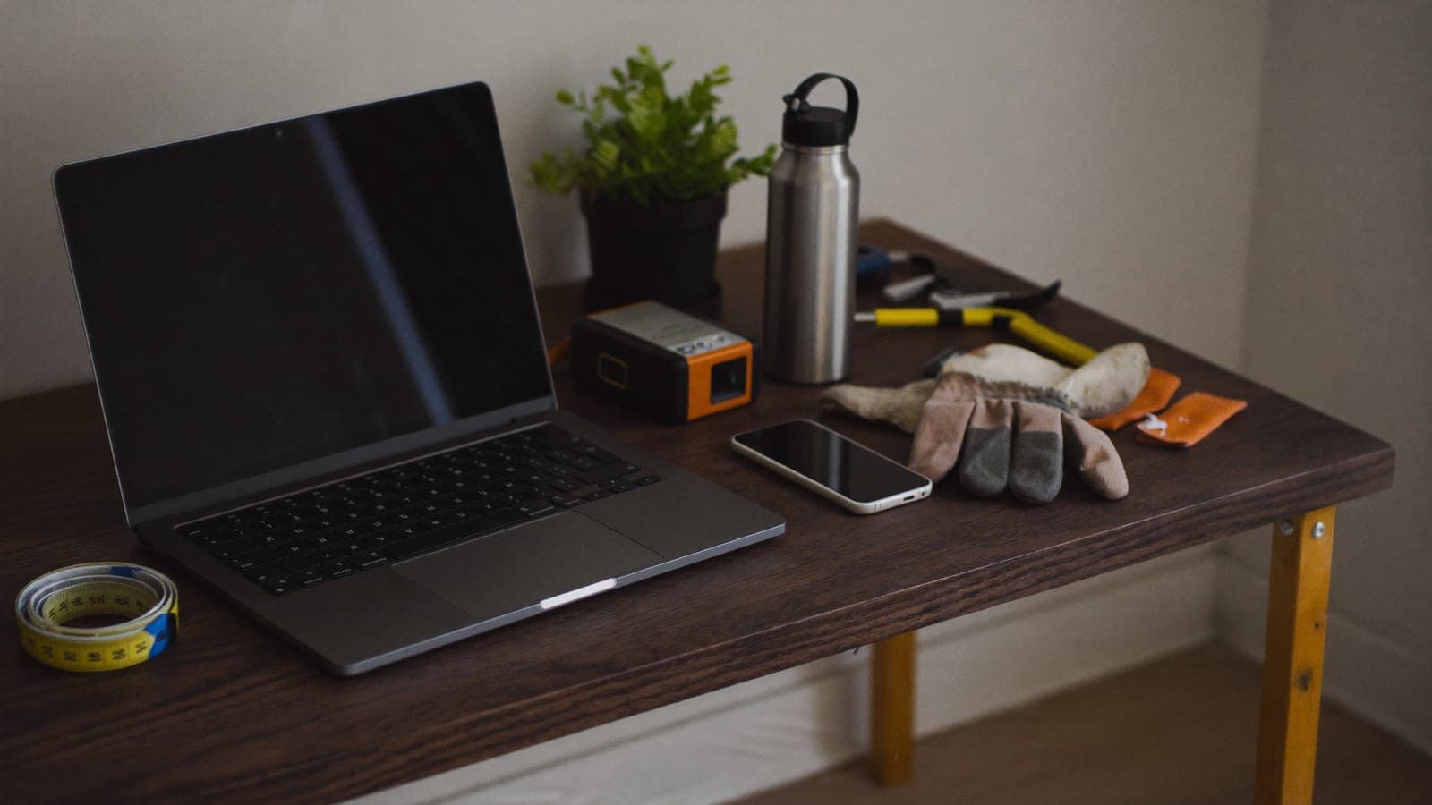 A home services business owner reviewing quotes on a laptop and phone, with subtle workflow lines connecting a calendar, message, and quote-approval card
